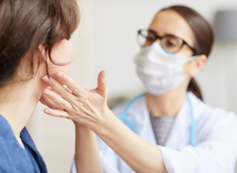 Provider giving facial exam