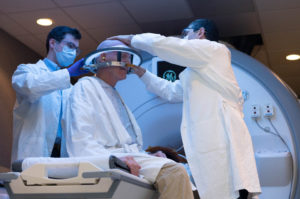 Two healthcare providers working with a patient who will receive focused ultrasound