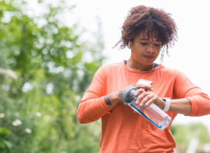 woman exercising and checking her smartwatch