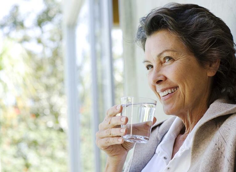 woman drinking a glass of water