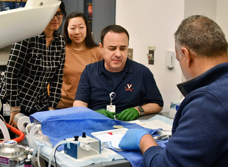 Antonio Abbate, MD, talking with a colleague