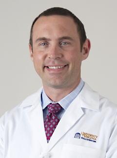 Dr. Michael Hainstock in a white coat
